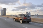 2013 BMW X5 xDrive35i in Sparkling Bronze Metallic - Driving Rear Left Three-quarter View